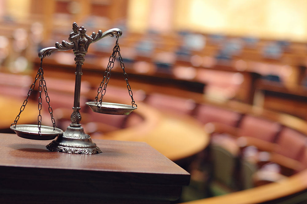 A close up of the scales of justice on top of a table