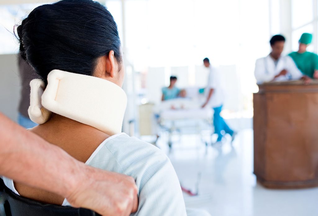 A person with a neck brace on in an office.